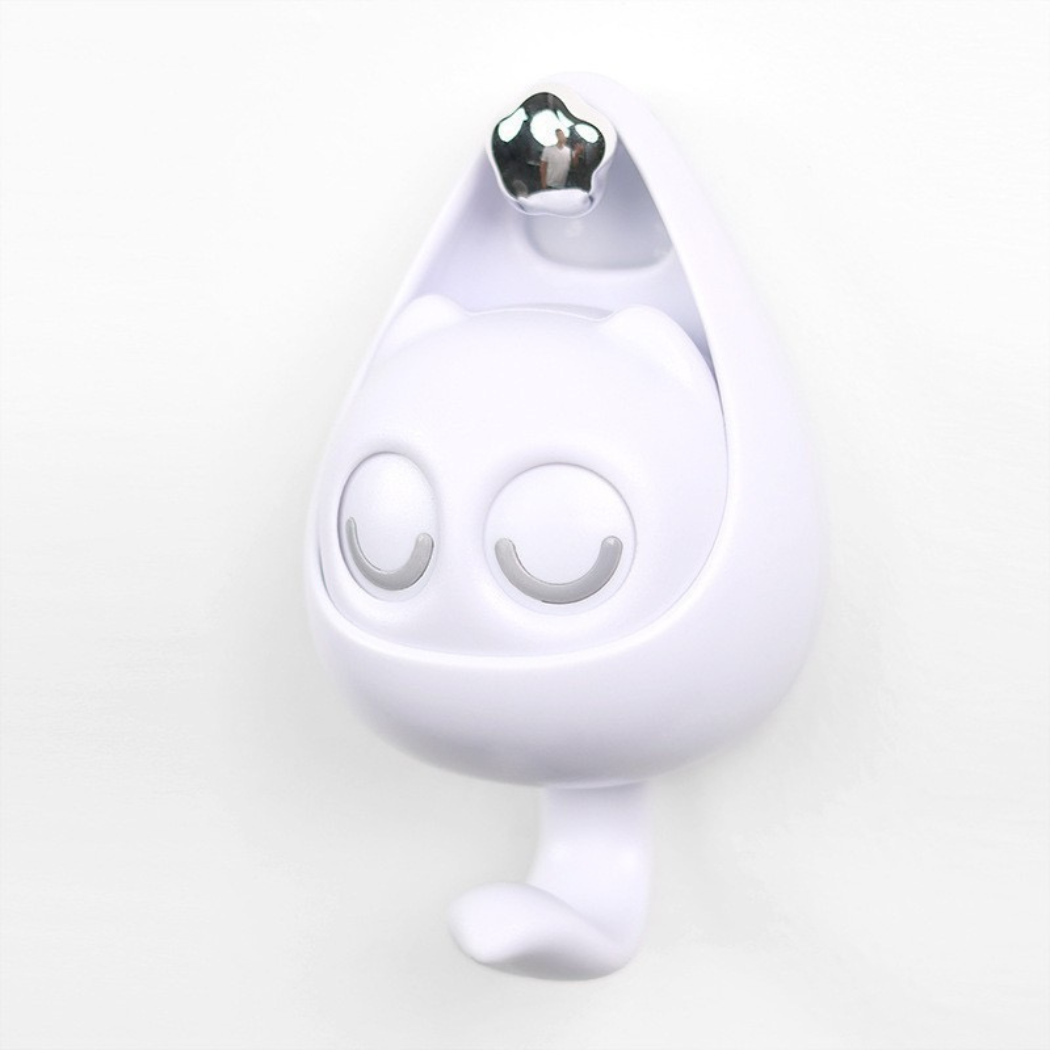 White electronic device with a silver top on a light gray background